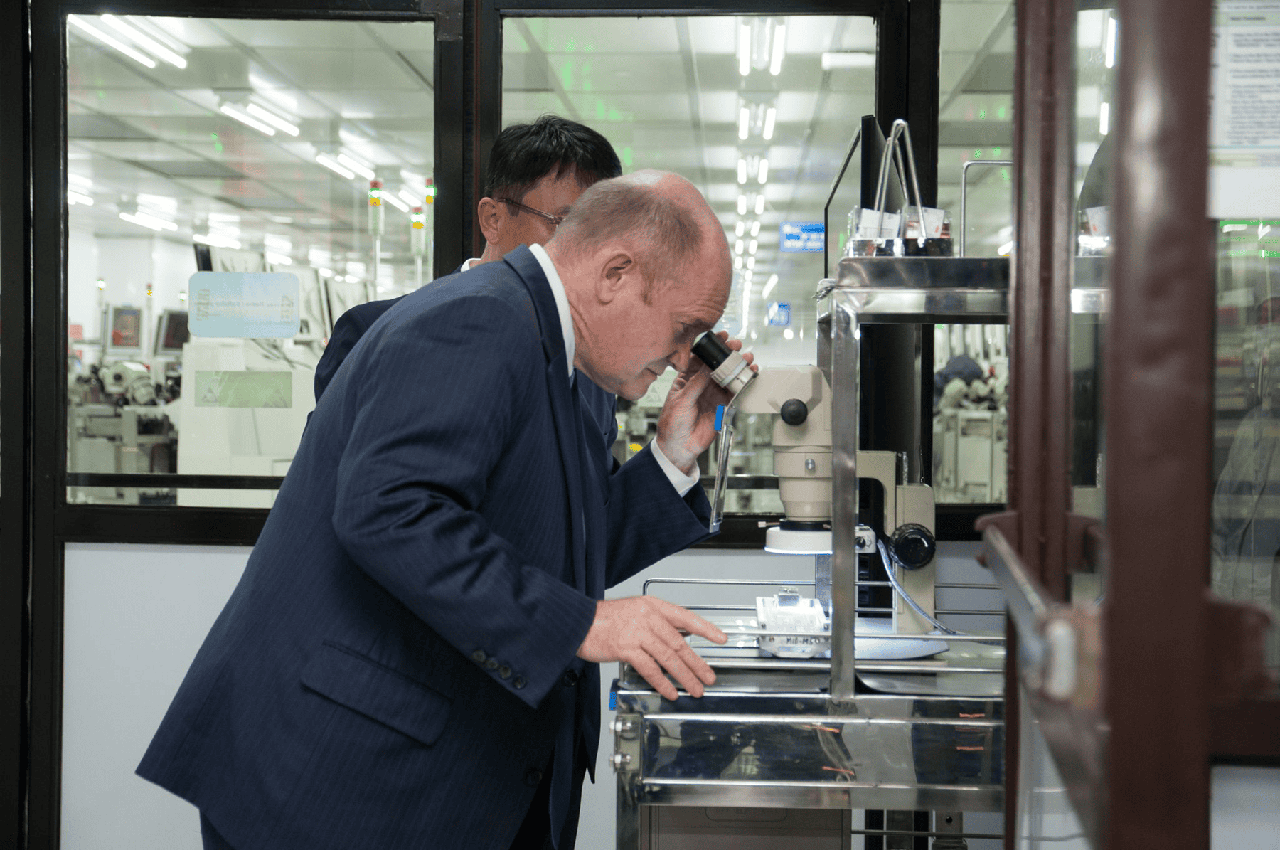 Congressman Coons looking through microscope