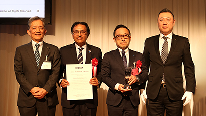 Amkor Japan Sales team on stage receiving award.